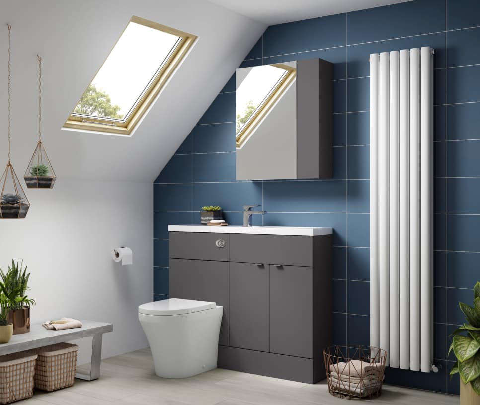 modern bathroom with radiator toilet mirrored cupboard and blue tiles with a skylight window